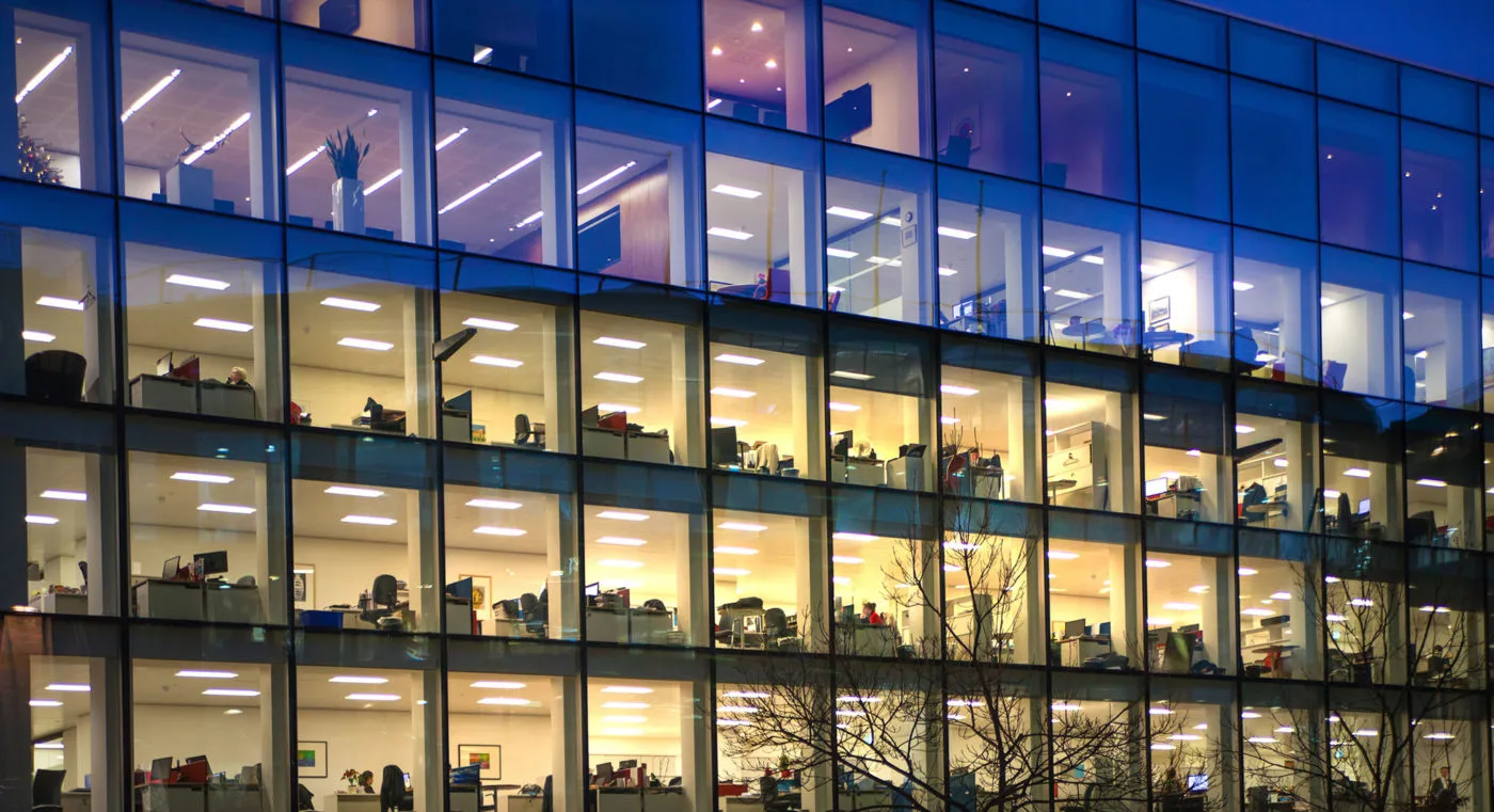 An office building with lights at night